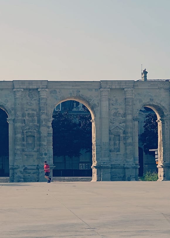 Porte de Mars in Reims during the day, Roman triumphal arch with large stone arches in Champagne, France.