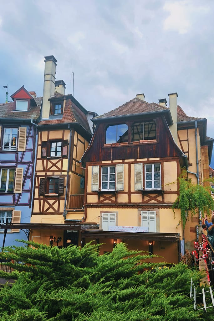 half timbered house with glorious colous by the canal in colmar
