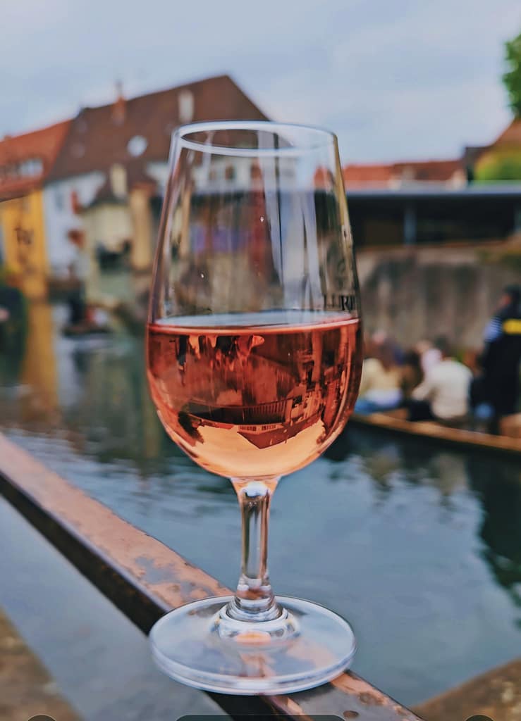 glass of rose wine reflecting the " gondola" and the houses behind